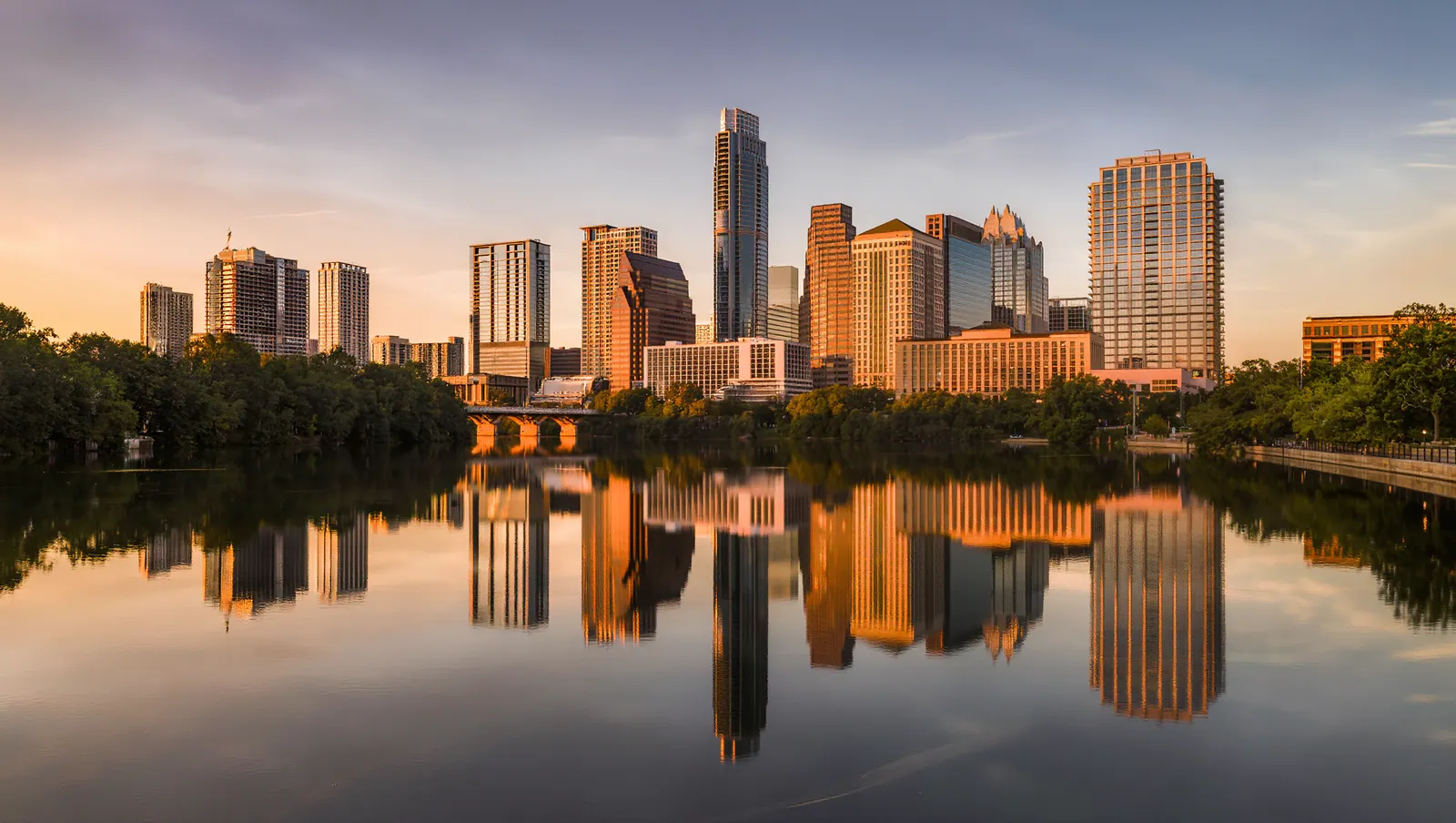 Austin skyline across Lady Bird Lake at golden hour