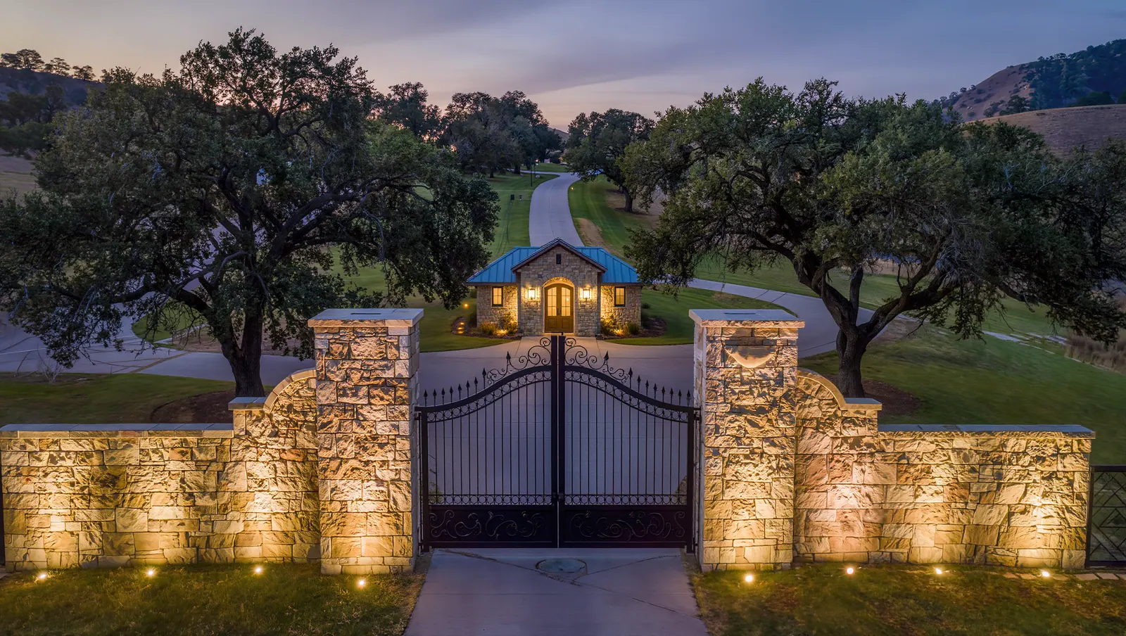 Limestone walls and iron gates at a Hill Country gated community
