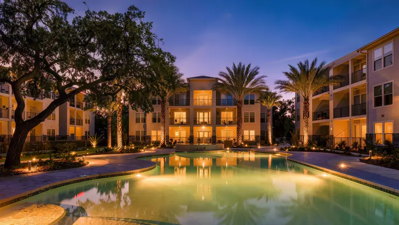Apartment community courtyard and pool at twilight