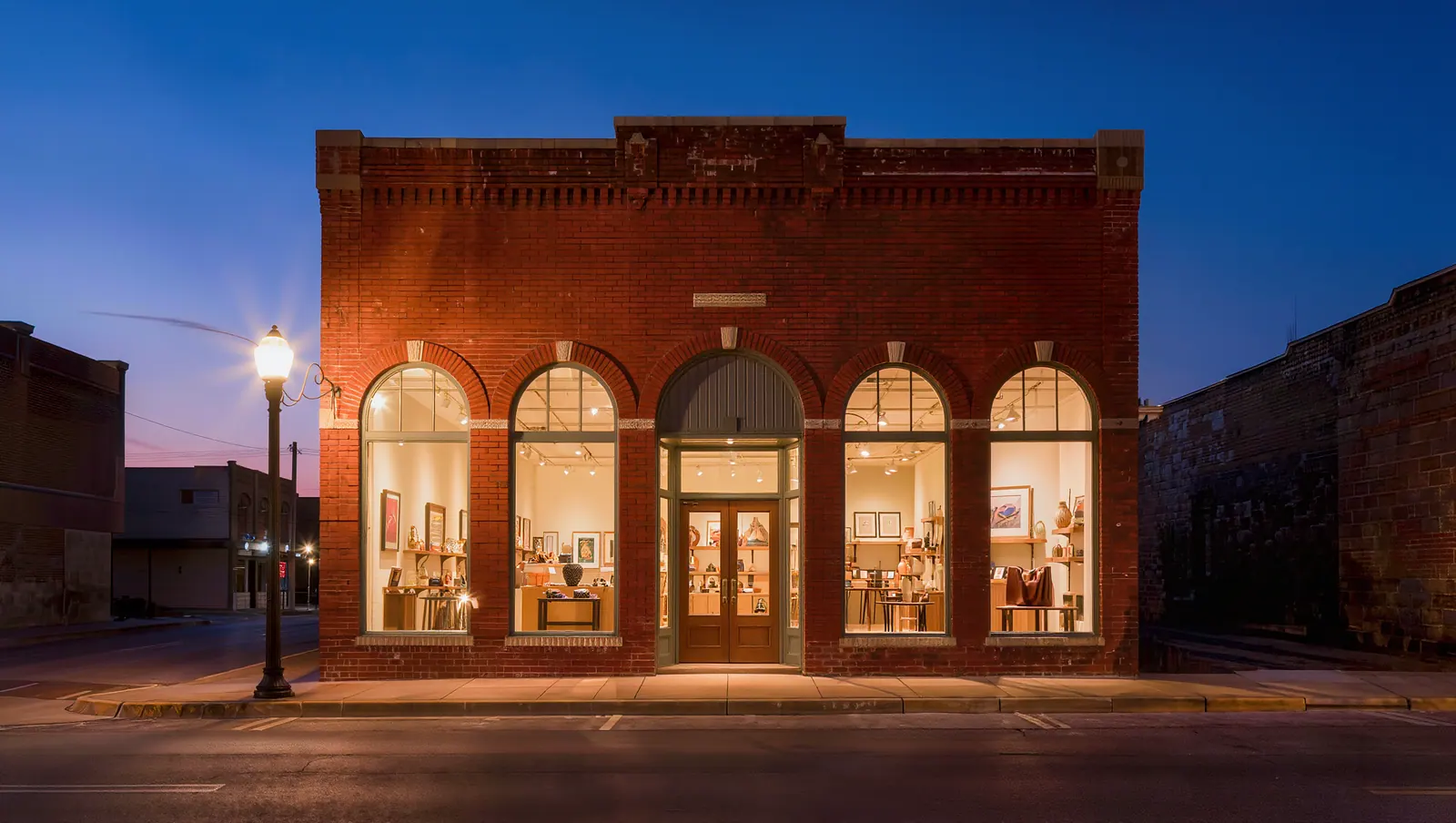 Brick storefront on a historic Texas main street at blue hour